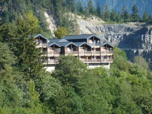 un edificio junto a una colina con árboles en Haus Stadel Wohnung Nr. 36 en Albinen