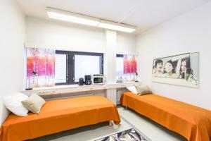 a hotel room with two beds and a television at Forenom Hostel Vantaa Airport in Vantaa