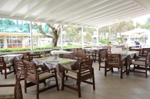 a row of tables and chairs in a restaurant at Hotel Mirage in Milano Marittima
