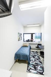 a bedroom with a bed and a desk at Forenom Hostel Vantaa Airport in Vantaa