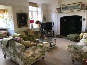 a living room with two couches and a tv at Coombe Lodge Farm House in Bristol