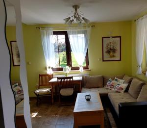 a living room with a couch and a table at Nowy Domek Pod Kogutkiem in Górki Wielkie