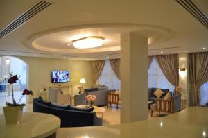- un salon avec un plafond rond doté d'une table et de chaises dans l'établissement Larissa Suites, à Khobar