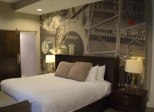 
a bed with a white bedspread and pillows at Hotel at the Lafayette Trademark Collection by Wyndham in Buffalo
