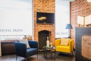 a living room with two chairs and a fireplace at Trend Samara in Samara