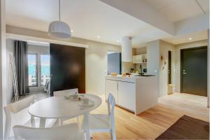 a kitchen and dining room with a table and chairs at Forenom Aparthotel Oslo in Oslo