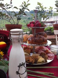 a table with three plates of pastries and a vase at Podere Delle Fanciulle in Pistoia