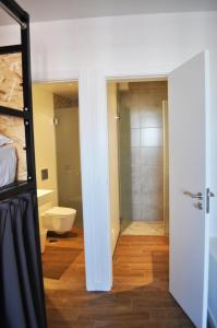 a bathroom with a shower and a toilet in a room at Casa Portas de Portugal in Lagos