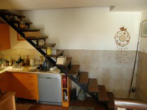 a kitchen with a spiral staircase in the corner at Stone House in Buljarica in Petrovac na Moru