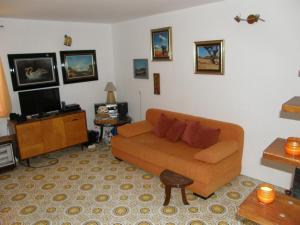 a living room with a couch and a tv at Stone House in Buljarica in Petrovac na Moru