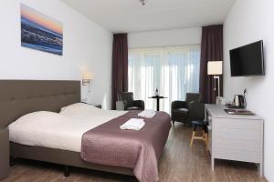 Postel nebo postele na pokoji v ubytování Hotel Cafe Restaurant Duinzicht