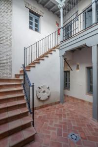 a staircase in a building with a brick floor at Casas de Sevilla - Apartamentos Tintes12 in Seville