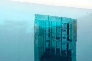 a reflection of a building in the water at Orloff Resort in Spetses