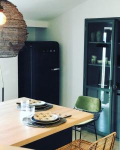 a kitchen with a table with plates of food on it at Appartement Casalea - Casadibastia - Bastia centre in Bastia