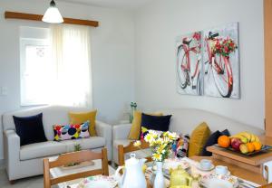 a living room with a couch and a table at Sea Daffodil apartments in Kissamos