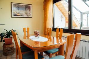 a dining room table and chairs with a table and a window at Apartment Bor in Bovec