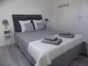 a bedroom with a large bed with two pillows on it at Les Tournelles in Versailles