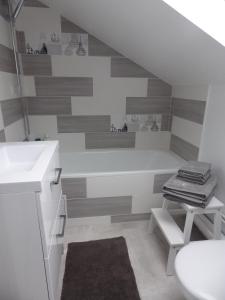 a bathroom with a sink and a toilet at Les Tournelles in Versailles