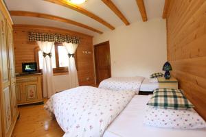 a bedroom with two beds and a tv in it at Gasthaus Maria in Borlova +94 photos