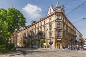 a large building on a street with people walking on the street at The Old Town View in Kraków