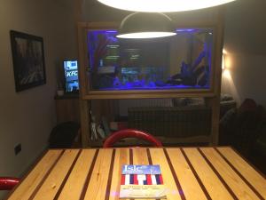 a table with a fish tank on top of it at Manhattan loft in Margate