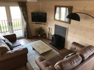 a living room with a couch and a fire place at Lunecliffe Country lodge-Lancaster Gateway to the Lakes in Lancaster