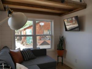 a living room with a couch and a window at Hygge Tiny Home in Leeds