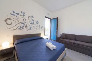 a bedroom with a bed and a couch at Amaka in Custonaci