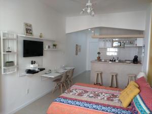 a living room with a bed and a kitchen at Nice Studio in Copacabana in Rio de Janeiro