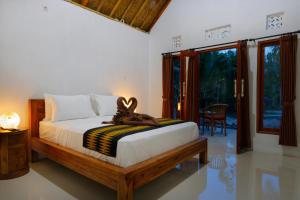 Ένα ή περισσότερα κρεβάτια σε δωμάτιο στο Dangin Kubu Bungalow