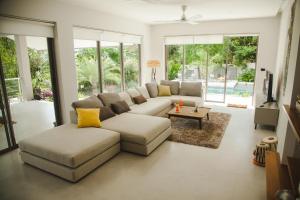 a living room with a couch and a table at Amaya Villa in Hinkong