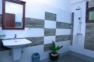 a bathroom with a sink and a shower at Kottamba Yala Stay & Safari in Tissamaharama +37 photos