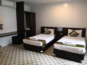 Säng eller sängar i ett rum på Chiangrai Green Park Resort