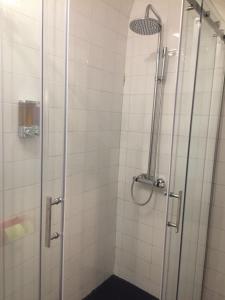 a shower with a glass door in a bathroom at Casa da Joana! in Murça