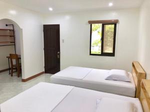 Casa de Moalboal客房内的一张或多张床位