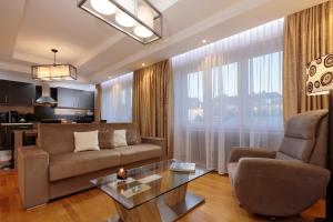 a living room with a couch and a table at The Queen Luxury Apartments - Villa Giada in Luxembourg