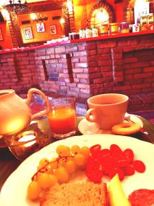 einen Tisch mit einem Teller Essen und einer Tasse Orangensaft in der Unterkunft Casa Oasa in Marezige