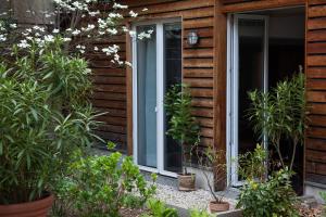 a sliding glass door of a house with plants at Garden-Loft Nürnberg in Nürnberg