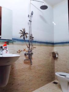 a bathroom with a shower and a sink and a toilet at Jolie Maison Đà Lạt in Da Lat +31 photos