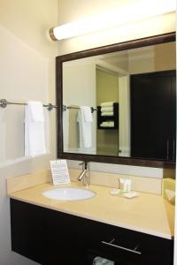 
a bathroom with a sink, mirror and a towel rack at Staybridge Suites Houston - IAH Airport, an IHG Hotel in Houston

