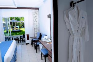 a hotel room with a robe hanging on the wall at Voyager Beach Resort in Mombasa