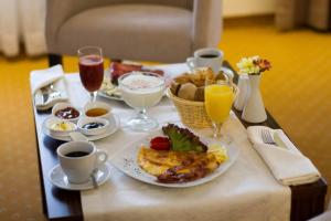 a breakfast table with a plate of food and drinks at Apartment Dil in Kulen Vakuf