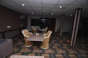 a dining room with a table and chairs in a room at Hotel Vaishnavi in Jaipur