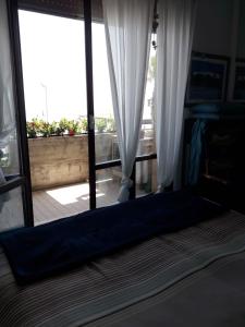 a view of a room with a large glass door at Soffio Di Mare in Porto Recanati