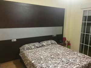 a bedroom with a bed with a large headboard at Residencial el Molino Churriana in Churriana de la Vega +23 photos