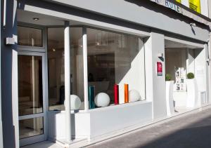 a store window with books and vases in it at Color Design Hotel in Paris