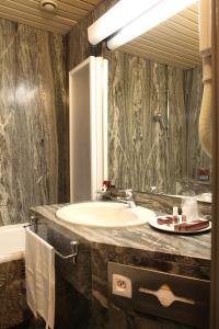 a bathroom with a sink and a mirror at Hotel Tiziano - Gruppo Mini Hotel in Milan