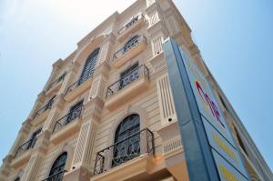 a tall building with many windows on the side of it at Hotel One Sukkur in Kalar Goth
