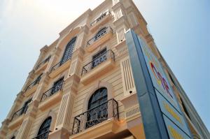 a tall building with many windows on the side of it at Hotel One Sukkur in Kalar Goth