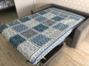 a blue and white quilt on top of a table at Sun & Sea 511 in Sesimbra